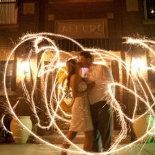 Image of bride and groom kissing with sparklers all around outside Northwest Indiana's wedding venue