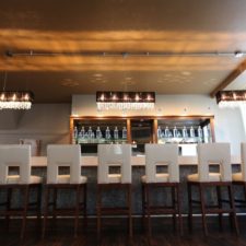 Image of elegant downstairs bar where guests can relax and grab drinks in The Allure Wedding Venue and Event Center