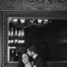 Image of bride and groom in front of mirror in back lounge at The Allure wedding venue