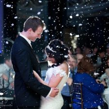 Image of Bride and Groom dancing with snow coming down in Northwest Indiana wedding venue