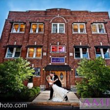 Image of the brick exterior of The Allure wedding venue with bride and groom kissing in the outdoor picture